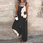 Loose printed overalls, sleeveless black with large white daisy floral front, wide-leg fit