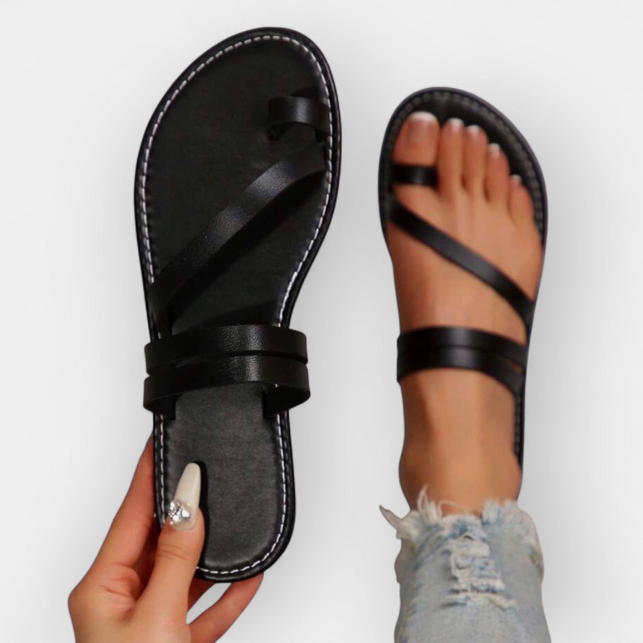 Black flat sandals with interwoven strap detail and adjustable ankle strap