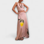Pink midi skirt with centered lemon-and-leaf print, relaxed drape