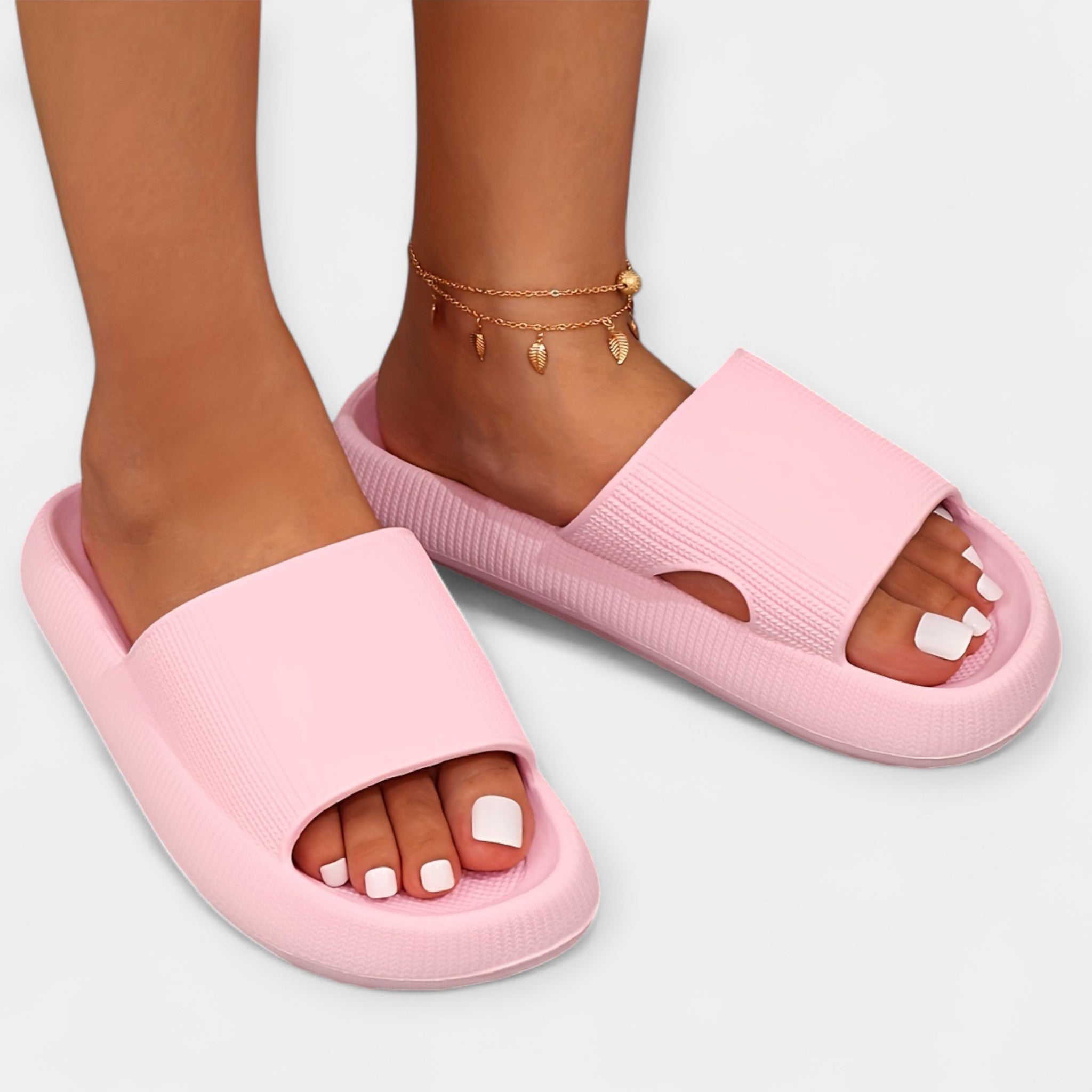 Light pink slide sandals with wide textured strap and open toe