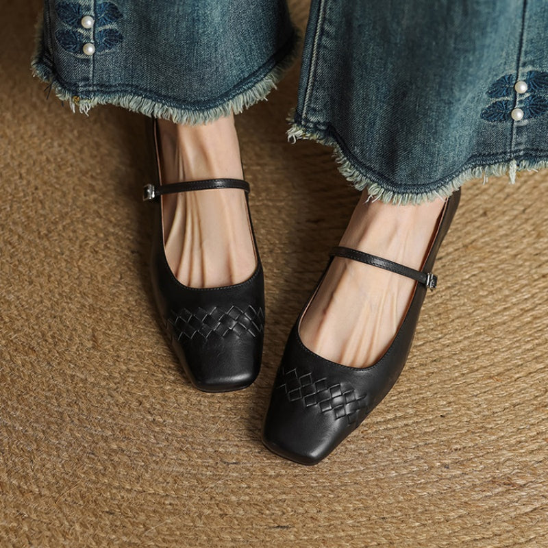 Black Mary Jane flats with square toe, woven vamp, and ankle strap buckle.