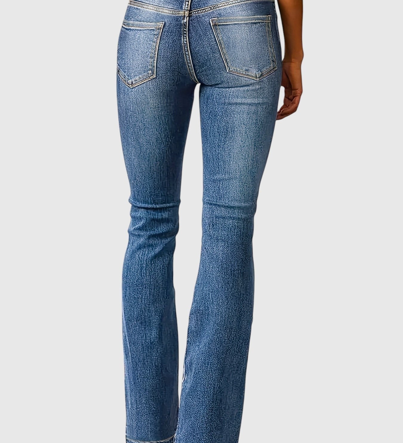 High-waisted slim-fit blue jeans, back view with patch pockets and belt loops