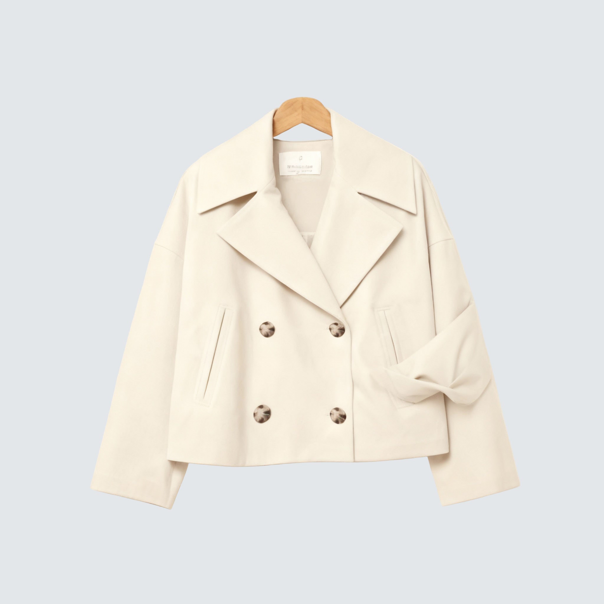 Destiny beige double-breasted coat, notch lapels, button front, flap pockets.