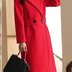 Red winter coat with notch lapels, double buttons, and waist belt