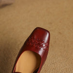 Red square-toe Mary Jane flat with woven panel detail on the vamp.
