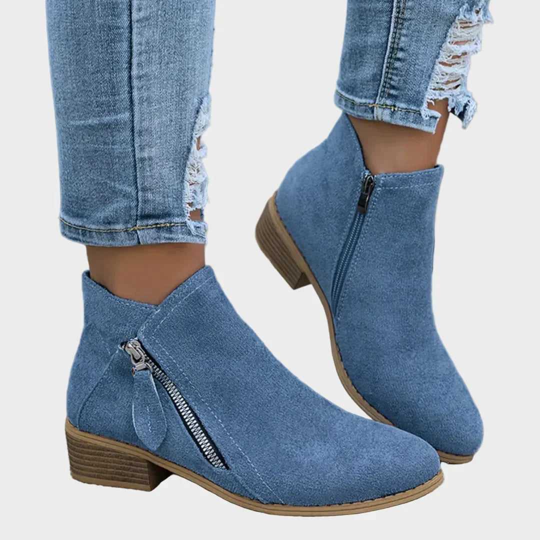 Blue suede orthopedic ankle boots with side zip and low wooden block heel.
