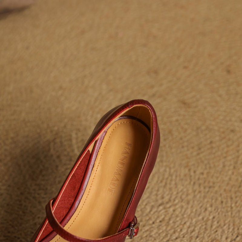 Red Mary Jane flat heel and insole view with ankle strap buckle hardware.