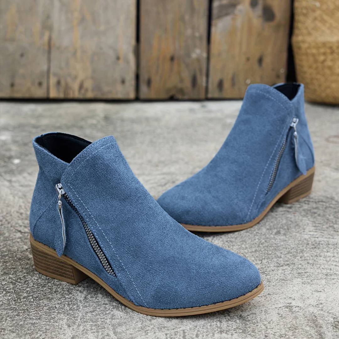 Blue suede orthopedic ankle boots with side zip and tan sole, low block heel.