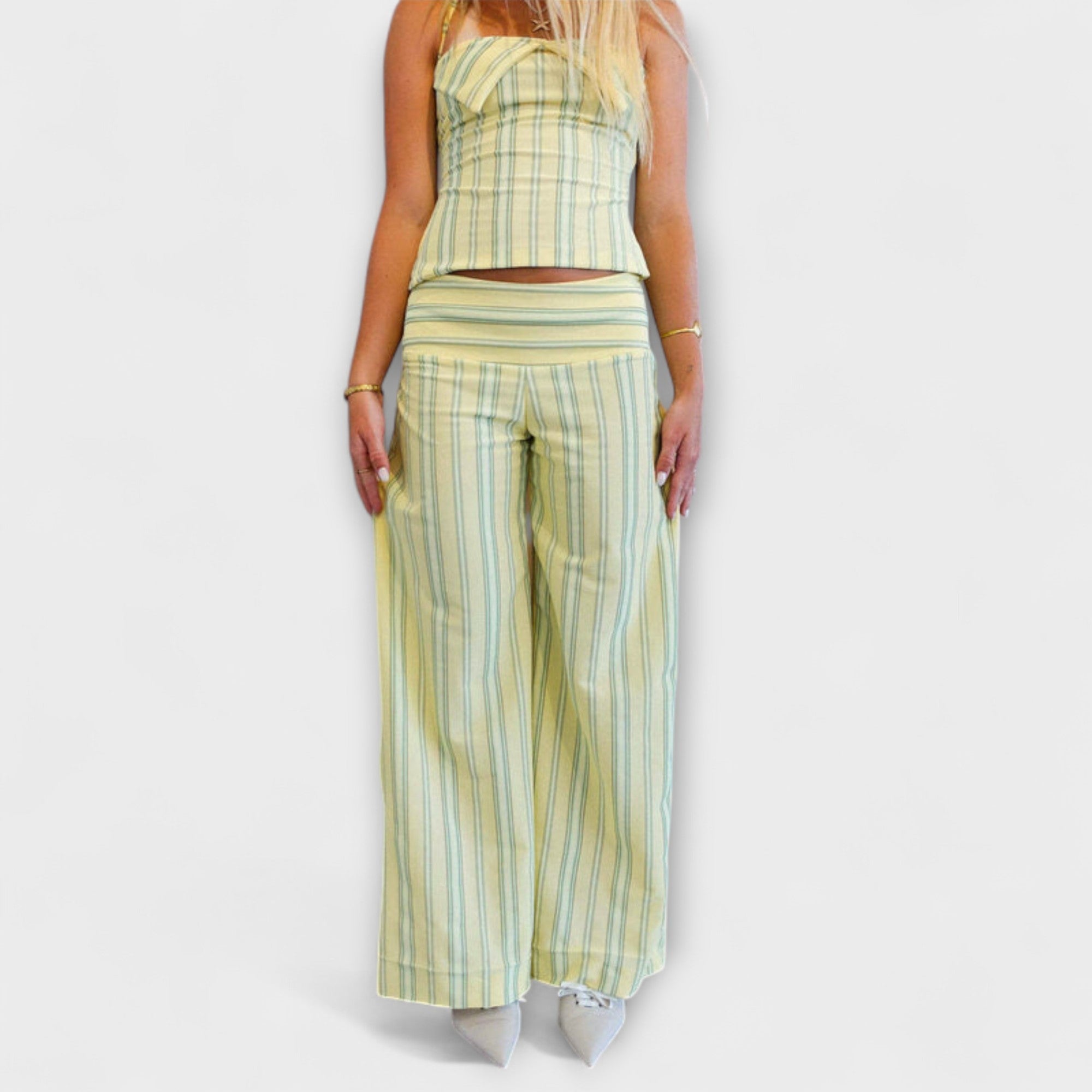 Striped two-piece pants suit with sleeveless halter crop top and wide-leg trousers