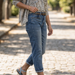 Light blue double-buckle sandals with block heel worn with blue jeans