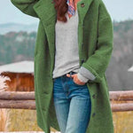 Long green hooded coat with button front and side pockets
