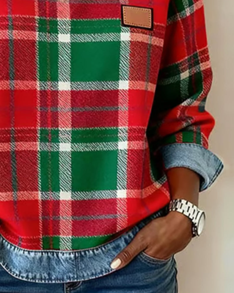 Women’s flannel pullover close-up: red-and-green plaid with denim trim and patch