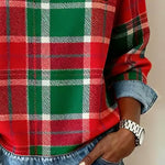 Women’s flannel pullover close-up: red-and-green plaid with denim trim and patch