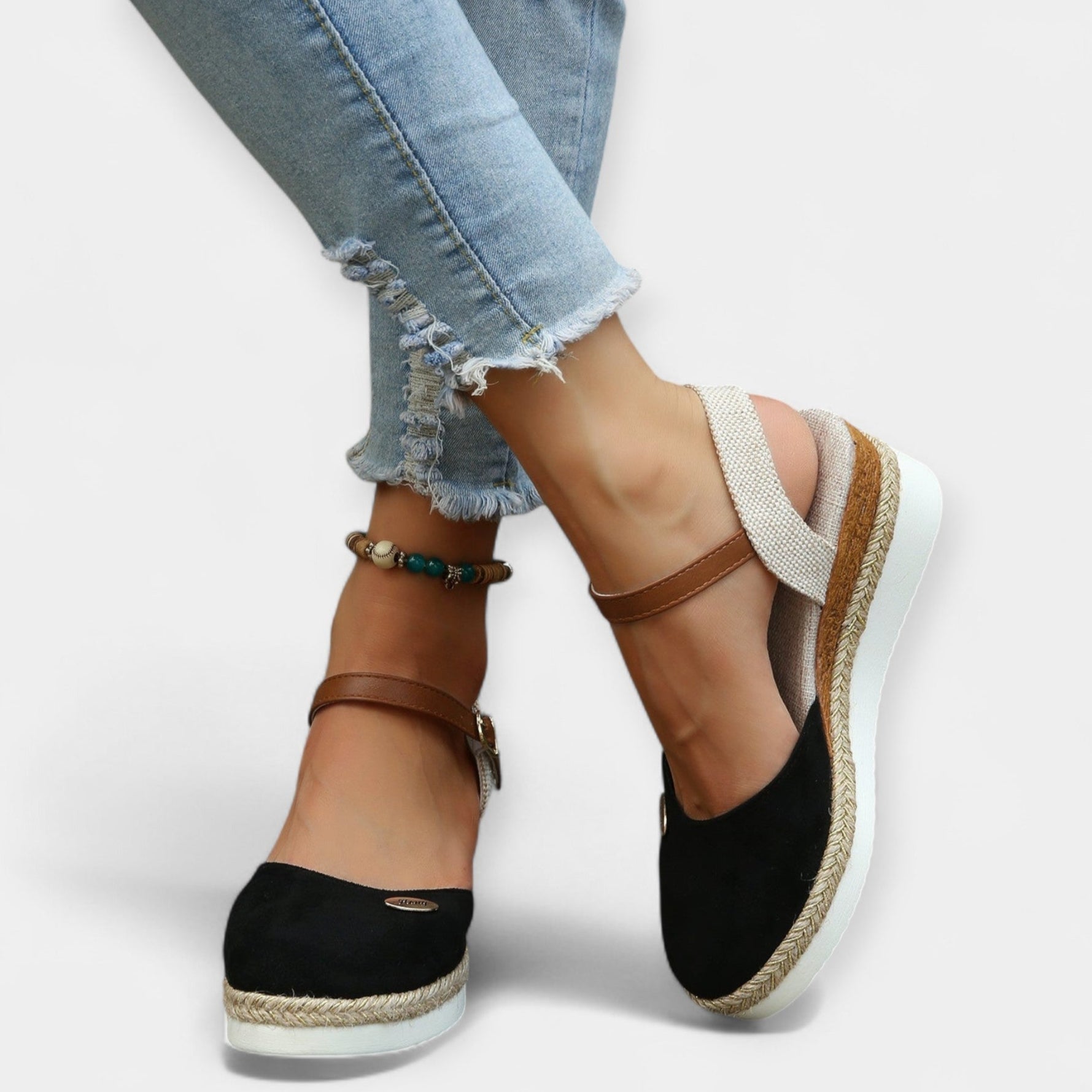 Orthopedic espadrilles with ankle strap and buckle, black suede uppers and jute sole.