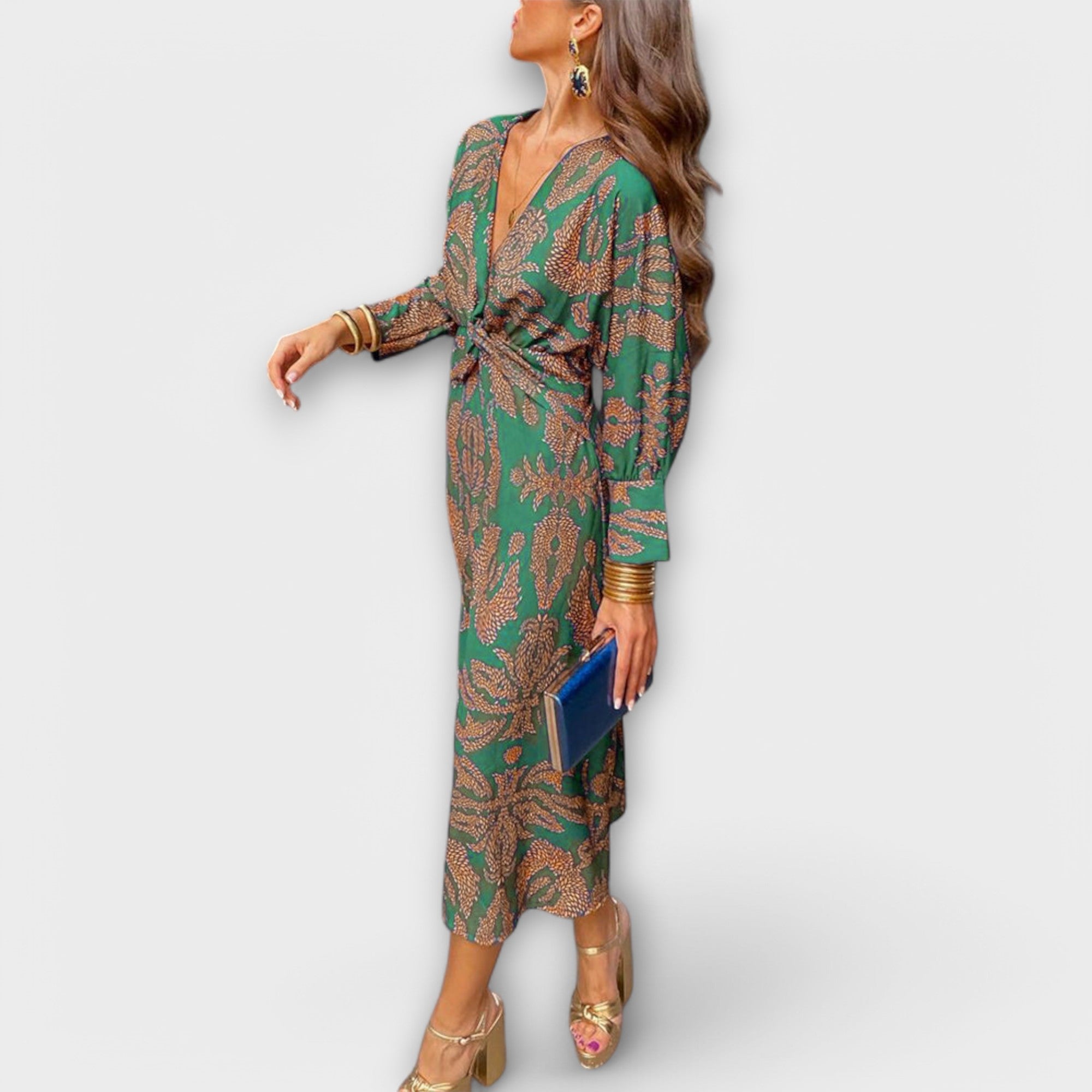 Elegant long-sleeve V-neck dress with green and gold ornate print, knotted waist tie