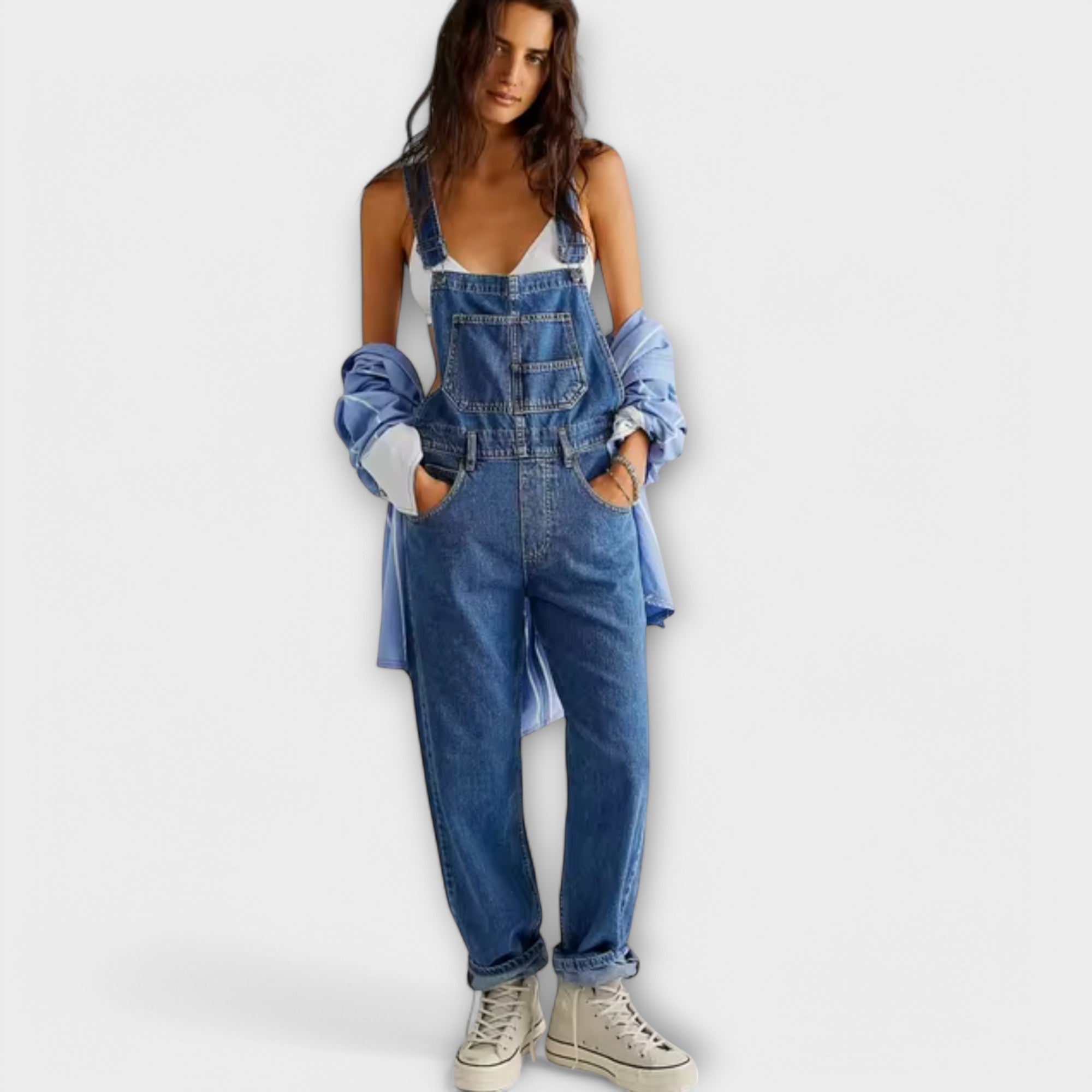 Blue denim loose-fit overalls with adjustable straps and front bib pocket