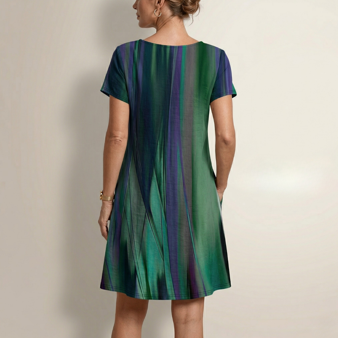 Back view of green and purple striped dress with short sleeves and round neck