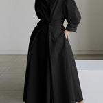 Black long button-front dress with puff sleeves and waist tie, full A-line skirt