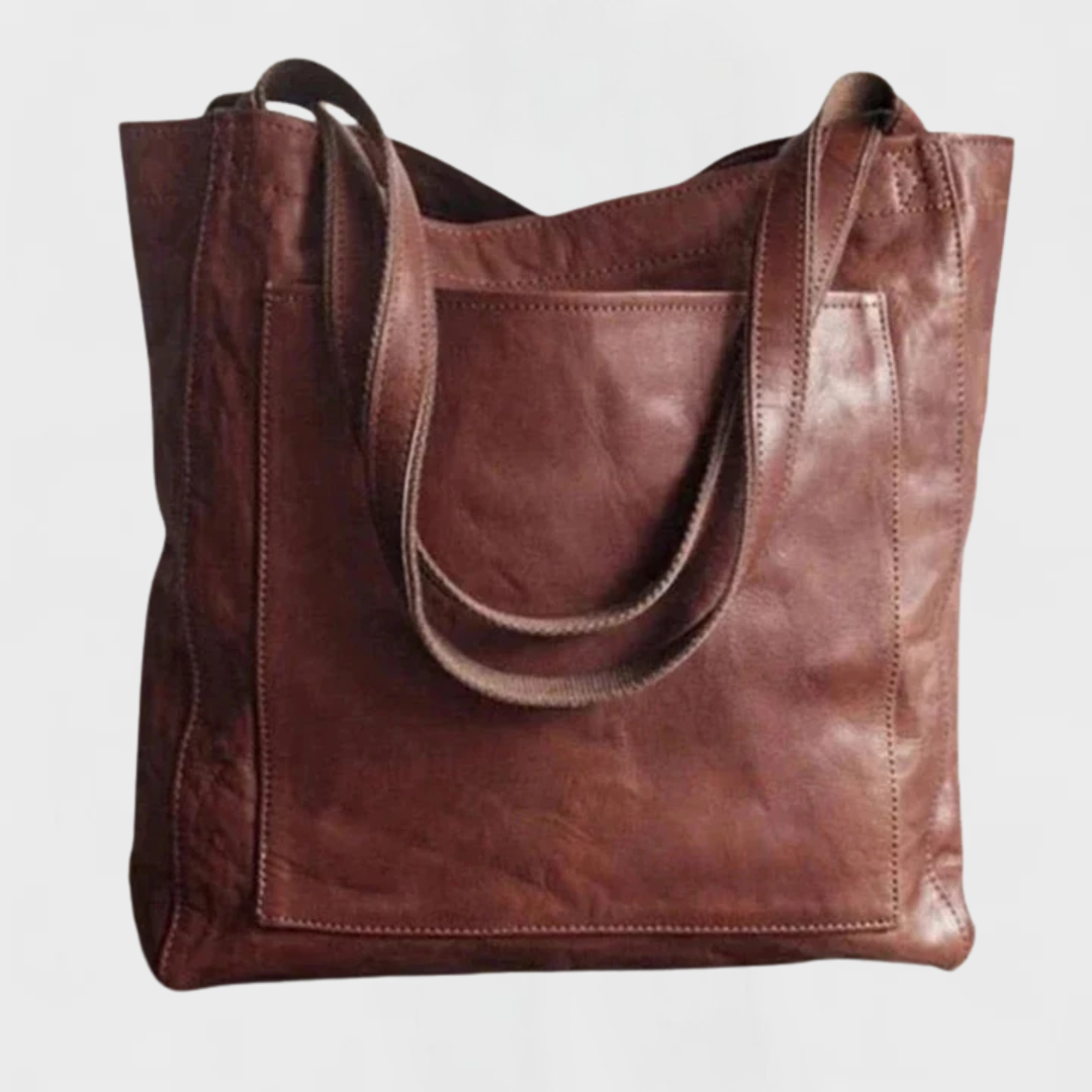 Dark brown leather tote bag with double top handles and front stitched panel.