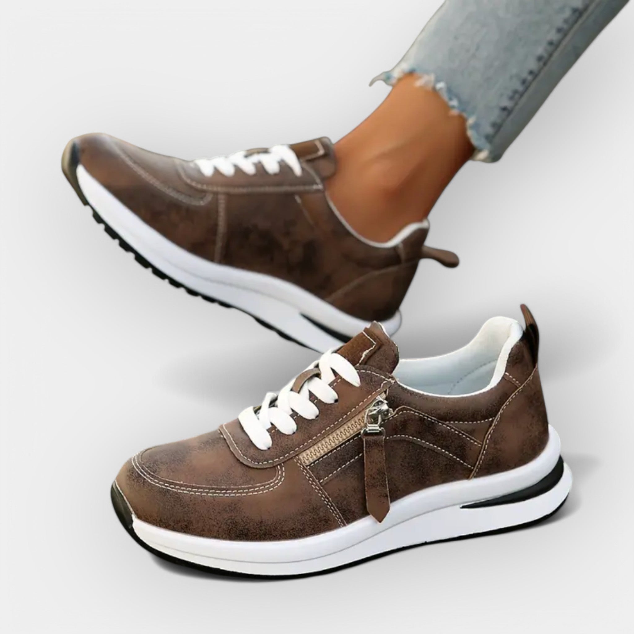 Anatomical brown sneakers with white laces, side zipper detail, and white sole.