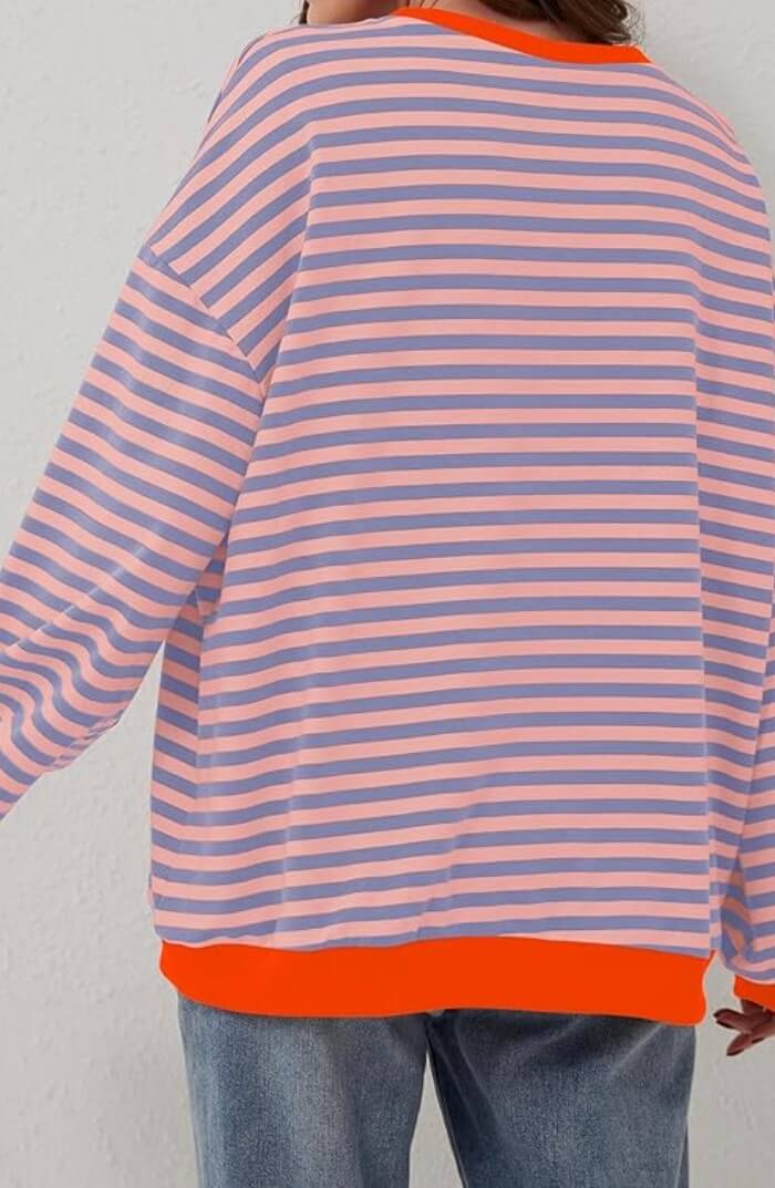 Peach and light blue striped pullover with orange trim at hem, long sleeves