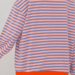Peach and light blue striped pullover with orange trim at hem, long sleeves
