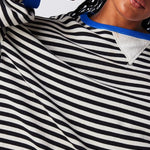 Black and white striped pullover with blue trim around neckline and cuffs