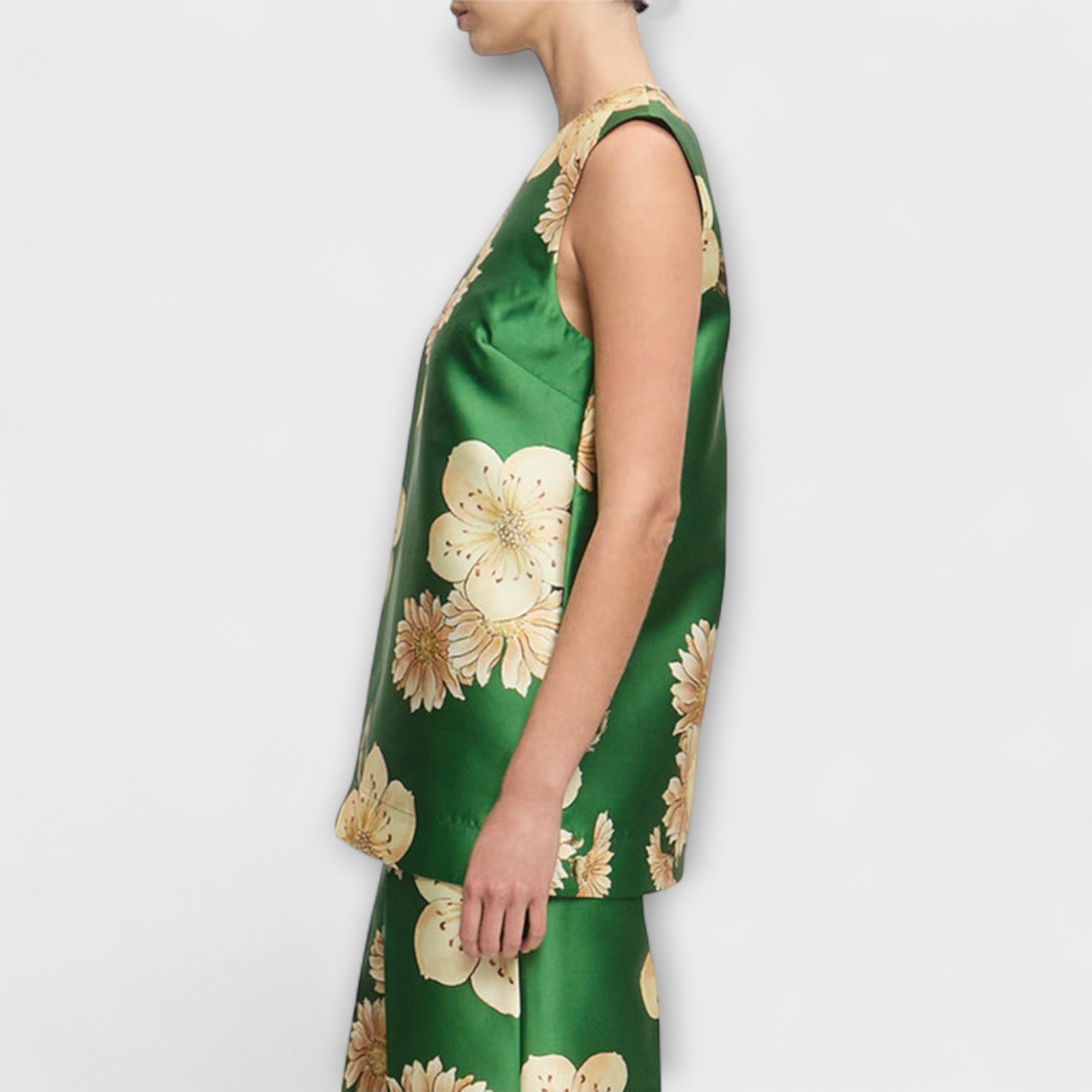 Sage green sleeveless jumpsuit with beige floral print, side profile