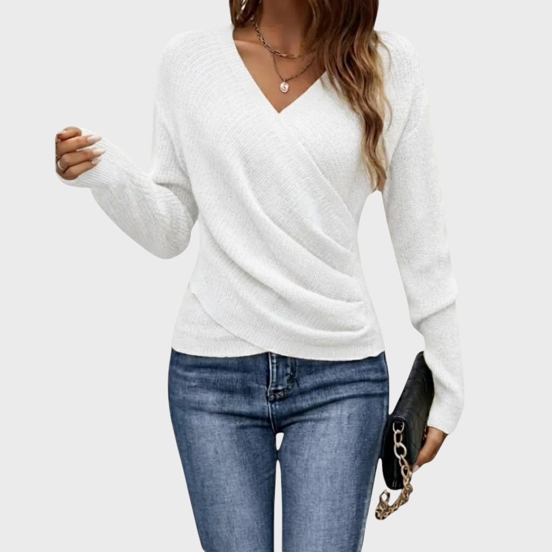 White structured V-neck pullover sweater with long sleeves and textured knit.