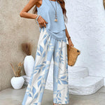 Light blue sleeveless layered top and wide-leg pants set with leaf print, full length