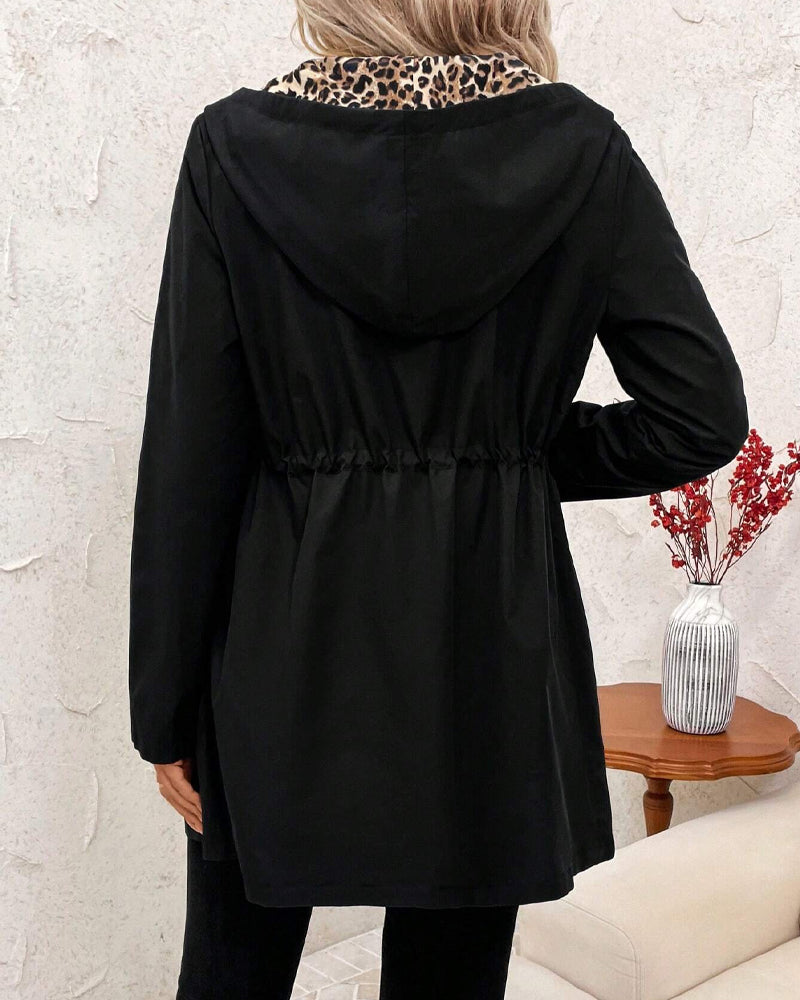 Black hooded reversible jacket with long sleeves, gathered back detail, zipper front
