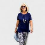 Elegant summer two-piece set with navy short-sleeve top and monochrome patterned pants