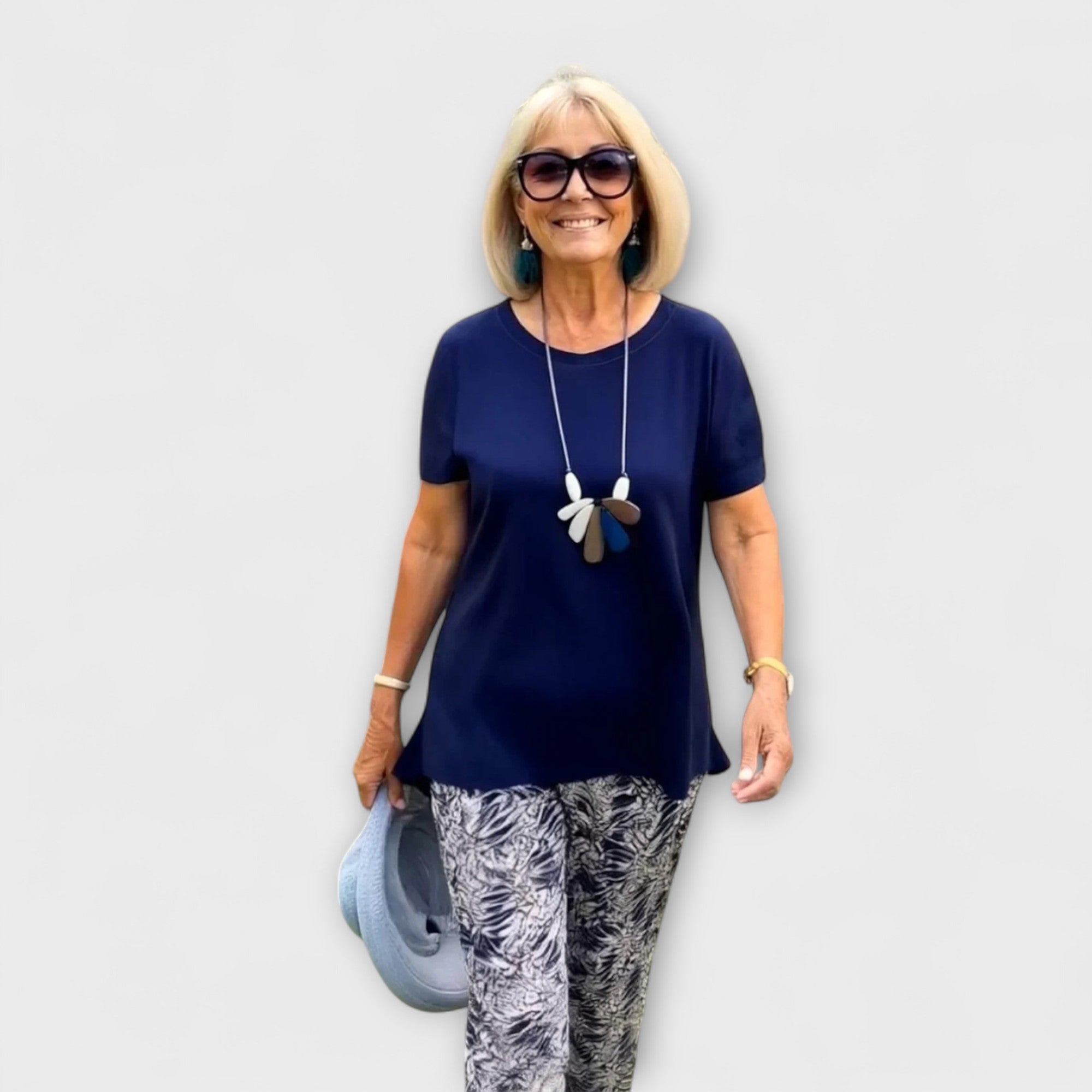 Elegant summer two-piece set with navy short-sleeve top and monochrome patterned pants