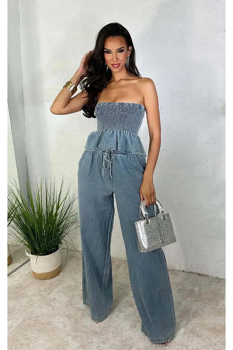 Light blue denim two-piece set with strapless smocked peplum top and wide-leg pants