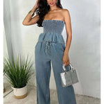 Light blue denim two-piece set with strapless smocked peplum top and wide-leg pants