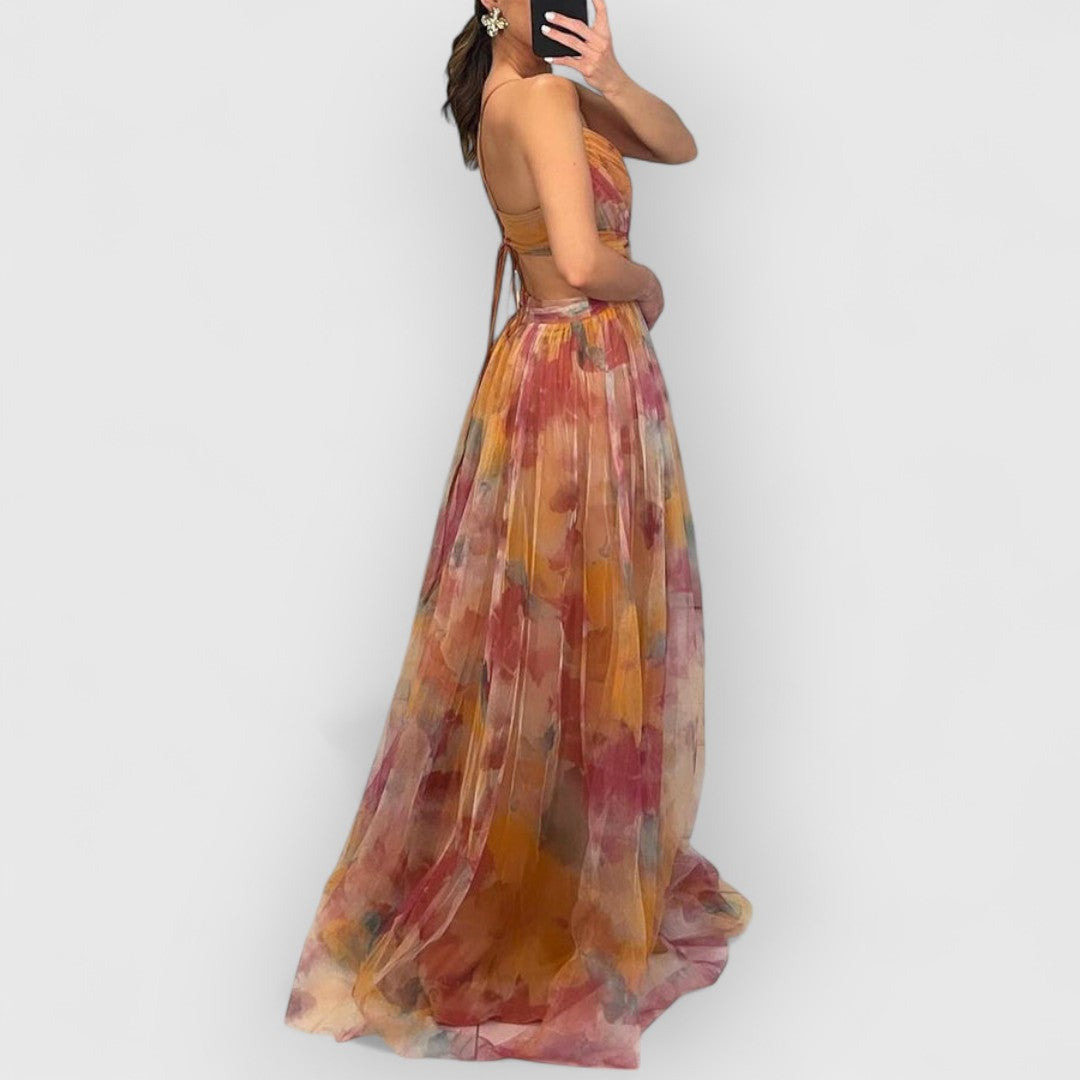 Orange-pink maxi dress with spaghetti straps and multicolor floral print, layered hem