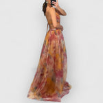 Orange-pink maxi dress with spaghetti straps and multicolor floral print, layered hem