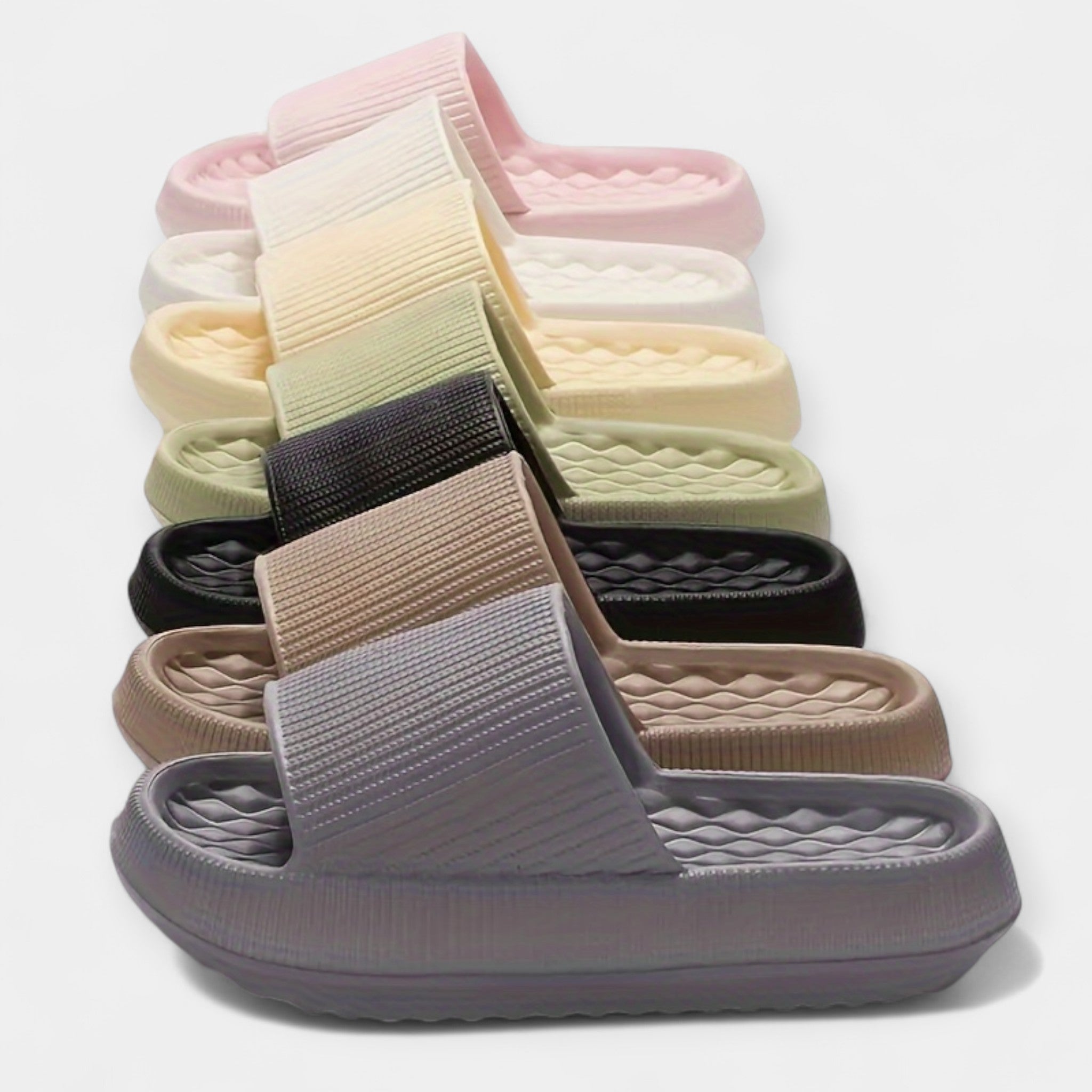 Stack of colorful textured slide sandals with thick soles and wide straps