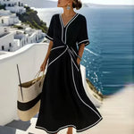 Black maxi wrap dress with V-neck, short sleeves, knot waist and white contrast trim