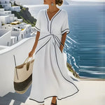 White maxi wrap dress with V-neck, short sleeves, knot waist and black contrast piping