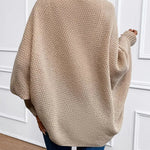 Beige knit cardigan draped back view, open front, long sleeves.