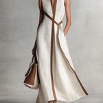 Elira linen dress in off-white with deep V-neck and diagonal tie panel, sleeveless maxi