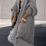 Light gray long knit cardigan with ribbed cuffs, buttonless open front, and side pockets