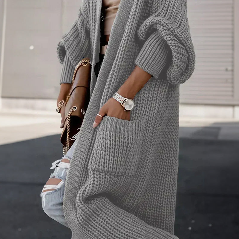 Light gray long knit cardigan with ribbed cuffs, buttonless open front, and side pockets