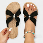 Women's wide bow sandals in black with braided footbed and large knotted bow front