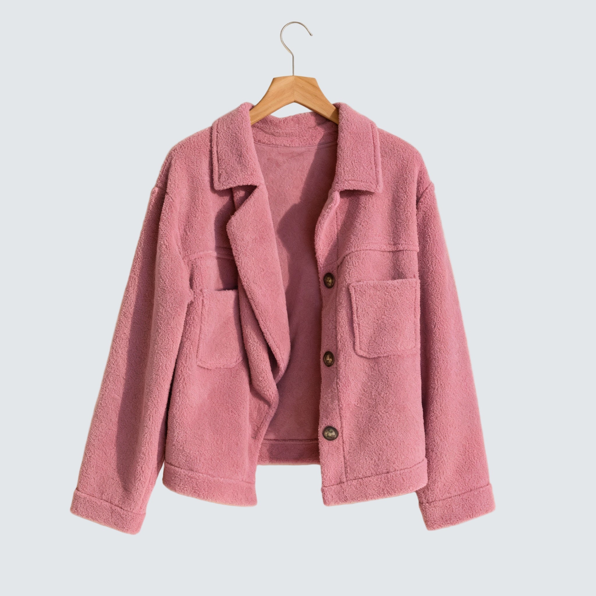 Pink button-front fleece jacket with two flap chest pockets and long sleeves