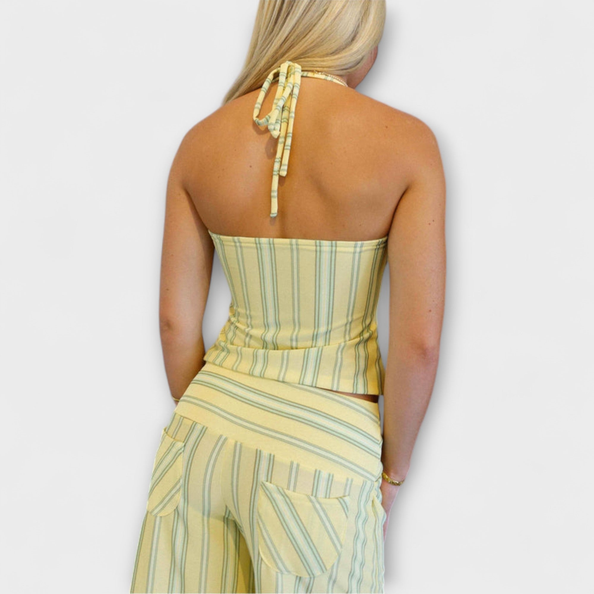 Back view of striped halter crop top with open-back tie and matching wide-leg pants