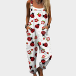 Loose printed dungarees in white with red ladybugs and flowers, front bib