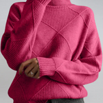 Magenta high-neck sweater with ribbed turtleneck and diagonal knit panel detail.