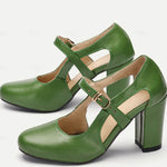 Light green leather-look heeled comfort Mary Jane shoes with cross straps and buckle.